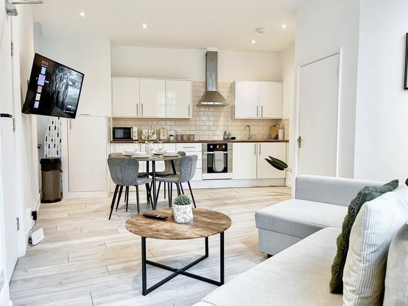 Old Street Apartment One, Shoreditch: Living room with white sofa and dining table