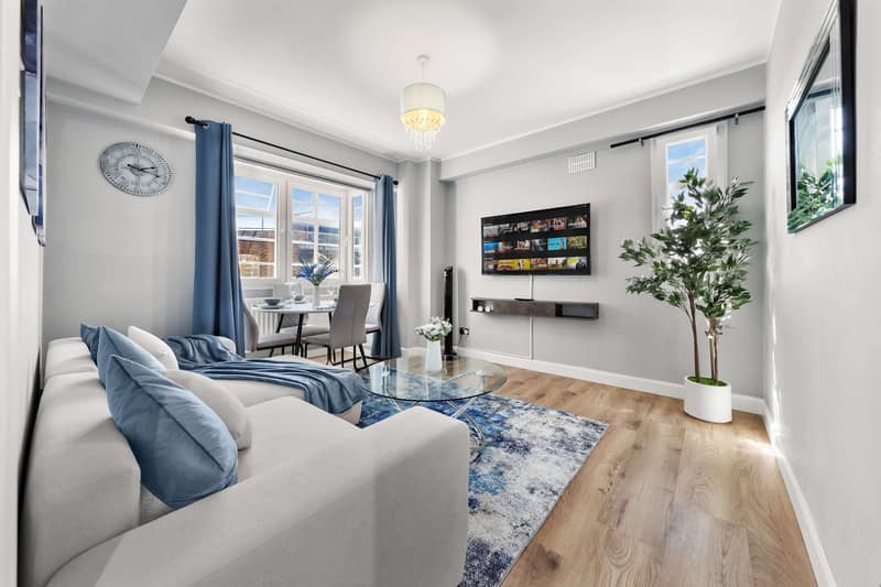 Regal Realms Paddington Two Bedroom, Paddington: Living room with pale sofa and wall-mounted television