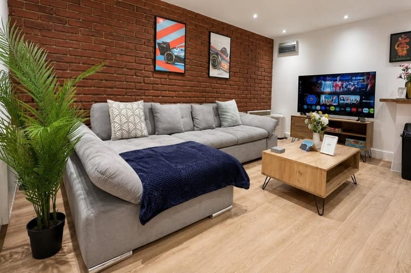 Shoreditch Four Bedroom Apartment, Shoreditch: Living room with grey sofa and wooden table