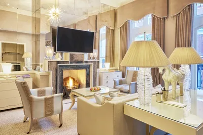 The Milestone Residences, Kensington: The Milestone Residences: Residence sitting room with fireplace and gold curtains, photo 2